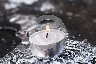 Peaceful Winter Tea Light On Cracked Ice Above A Frozen Table Stock Photo