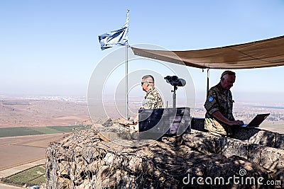 The peacekeeper from the UN forces looks toward Syria, being on a fortified point on Mount Bental, on the Golan Heights in Israel. Editorial Stock Photo