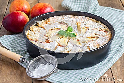 Peach clafoutis in a baking dish Stock Photo