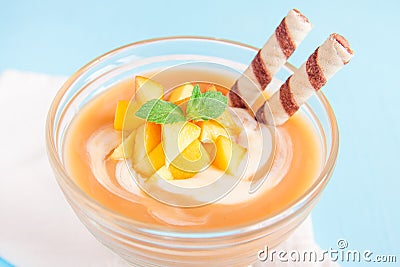 Peach dessert with waffle rolls Stock Photo