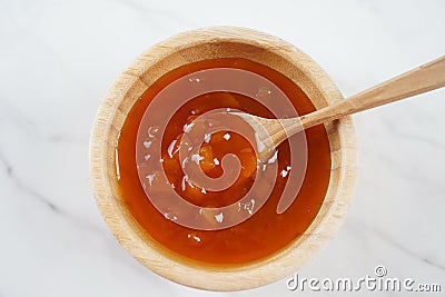 Peach jam in a wooden bowl. Canned fruit jam with ingredients Stock Photo