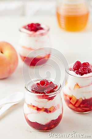 Peach and raspberry dessert with yogurt cream Stock Photo