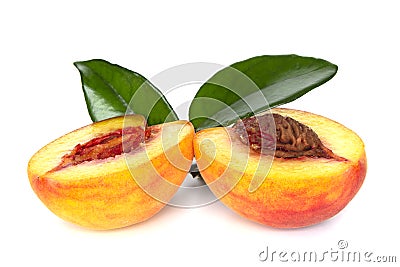 Peach sliced into two halves with leaf on white background isolated close up Stock Photo