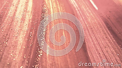 Peach tone scattered glitter on colorful surface. Hand drawn brush strokes theme design. Stock Photo