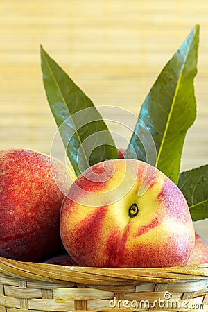 Peaches in weaved basket Stock Photo