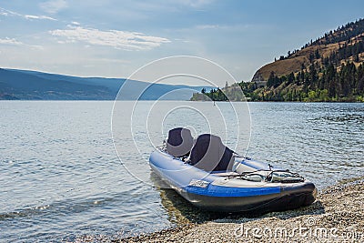 PEACHLAND, CANADA - AUGUST 01, 2020: blue inflatable kayak by the okanagan lake on a warm summer sunny day Editorial Stock Photo