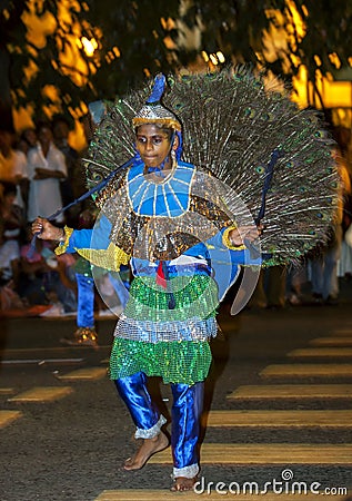 A Peacock dancer performs at the Esala Perahera in Kandy in Sri Lanka. Editorial Stock Photo