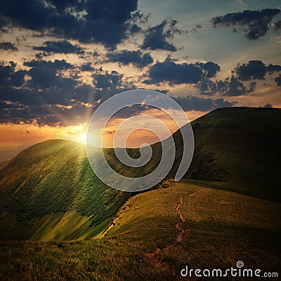 Peak of the hill and sunset rays Stock Photo