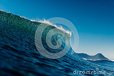 Peak of the wave in tropical ocean. Crashing perfect wave, ideal for surfing Stock Photo