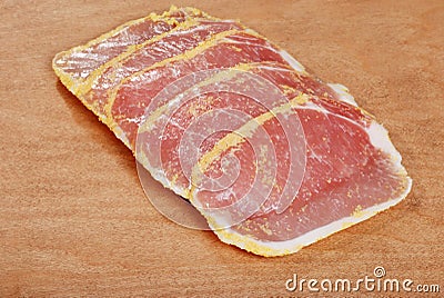 Peameal bacon on wood cutting board Stock Photo