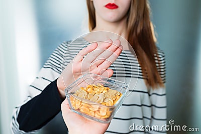 Peanut allergy concept - food intolerance. Young girl refuses to eat peanuts Stock Photo