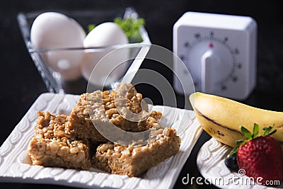Peanut Butter Marshmallow Squares, Eggs, Timer & Fruits Stock Photo