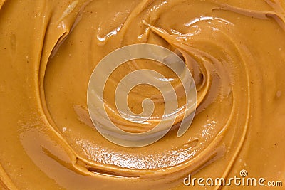 Peanut butter texture background. Creamy smooth brown nut spread swirl Stock Photo