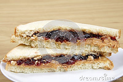 Peanutbutter and Jelly Sandwich cut in half served on plate Stock Photo