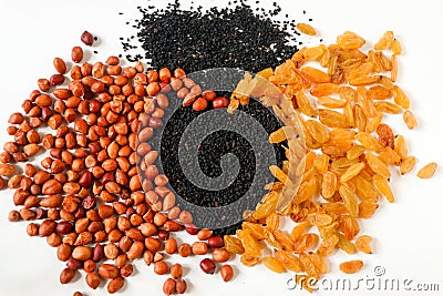 Peanuts, black cumin and raisins are pile. All together and make heart shape. Health and immunity concept Stock Photo