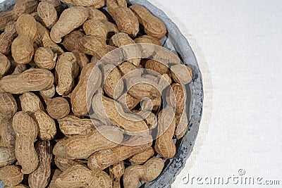 Peanuts in shell on the grey pate, white backgound, close up, co Stock Photo