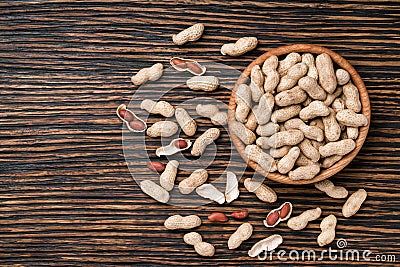 Peanuts on textured wooden background, top view. Stock Photo