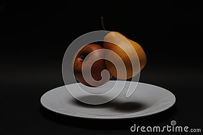 pear and apple floating on a porcelain plate Stock Photo