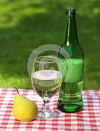 Pear cider and one pear Stock Photo