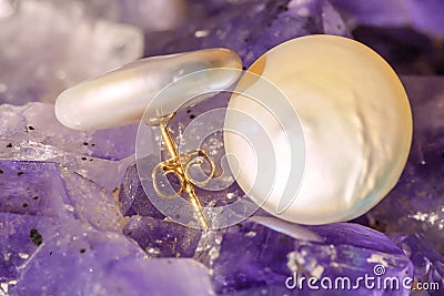 Pearl earrings on ametyst background Stock Photo