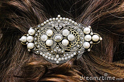 Pearl and filagree hair clasp in beautiful long reddish brown hair - close up Stock Photo