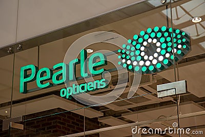 Pearle Opticien shop, illuminated sign above the store entrance. Editorial Stock Photo