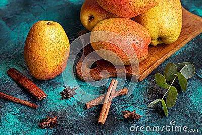 Pears on a dark background. Fresh, ripe fruits on a blue plate and in a box. Healthy eating Stock Photo