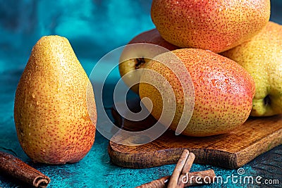 Pears on a dark background. Fresh, ripe fruits on a blue plate and in a box. Healthy eating Stock Photo