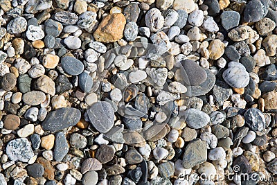 Pebble background texture with many pebbles of different sizes and shapes from Fistral beach Newquay Stock Photo