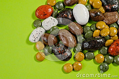 Pebble-dragee with apricots, chocolate, mandarin and marzipan. Tasty, bright, shot on a green background Stock Photo