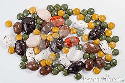 Pebble-dragee with apricots, chocolate, mandarin and marzipan. Tasty, bright, shot on a white background Stock Photo