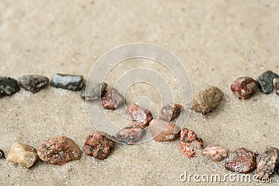 Pebble infinity symbol on sand selective focus Stock Photo