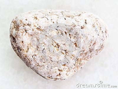 pebble of white Granite stone on white marble Stock Photo