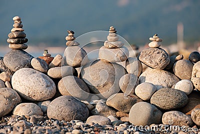 Pebbles on the beach collected in pyramids stones lie one on top of the other balance and harmony Stock Photo