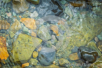 Pebbles in a slow moving stream Stock Photo