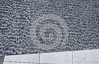 Pebbles stuck in cement glue. it forms a carpet of rounded stones. massage surfaces in the sauna and pool. in combination with whi Stock Photo