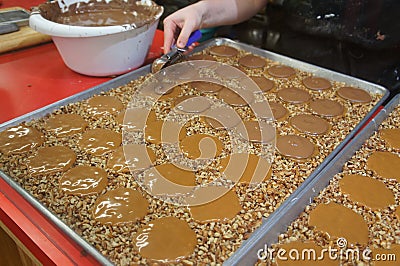 Pecan pralines and Milk Chocolate Gophers being made in a sweet shop in Savannah, GA Stock Photo