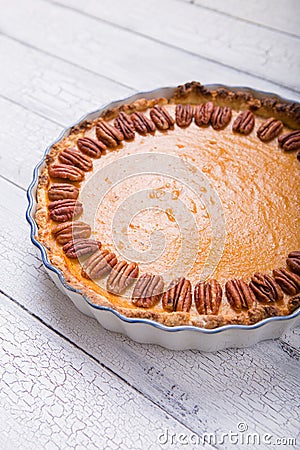 Pecan, Pumpkin, Thanksgiving Holiday Pies on a rustic table with decorative gourds. Top view Stock Photo