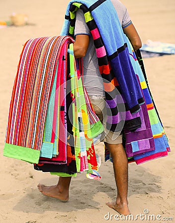 Peddler of towels and beach towels on the beach in summer Stock Photo