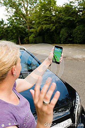 Pedestrian being hit by car while playing Pokemon Go on her smartphone Editorial Stock Photo