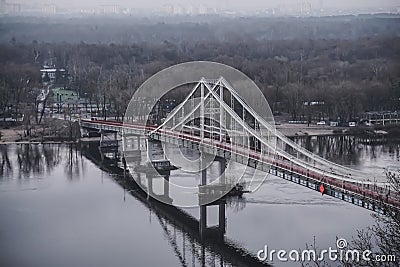 Pedestrian bridge with a bike path across the Dnieper River in the center of Kyiv Stock Photo