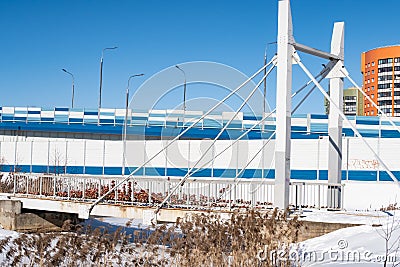 A pedestrian bridge over a frozen river, locks on the railing, signs of loyalty to the newlyweds, love forever Stock Photo