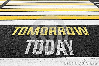 Pedestrian crossing with the inscription TODAY TOMORROW on the asphalt. Stock Photo