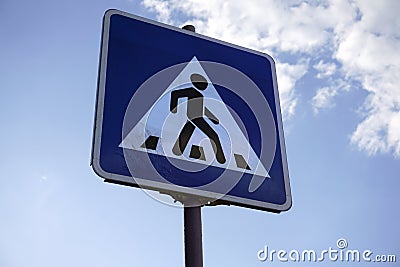 Pedestrian crossing road sign on a sky background Stock Photo