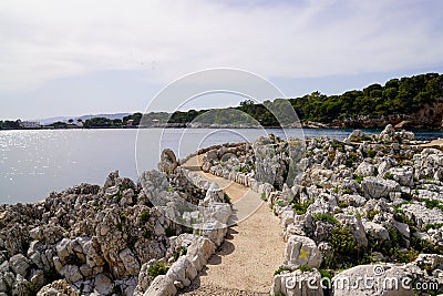 Pedestrian path by mediterranean sea on the tourist coast Juan-les-Pins in Antibes France Stock Photo