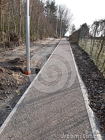 pedestrian path newly built compacted stone aggregate permeable surface soft for runners pedestrian cycle path forest path Stock Photo