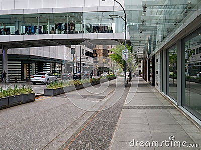 Pedestrian pavement, bike track, and car road in downtown of Vancouver, Canada. Stock Photo