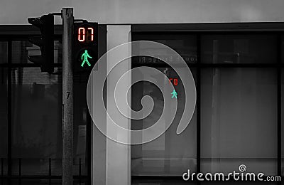 Pedestrian signals on traffic light pole. Pedestrian crossing sign for safe to walk in the city. Crosswalk signal. Green traffic Stock Photo