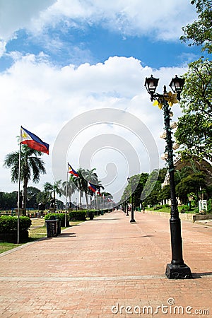 Pedestrian walkway through park in Manila Stock Photo