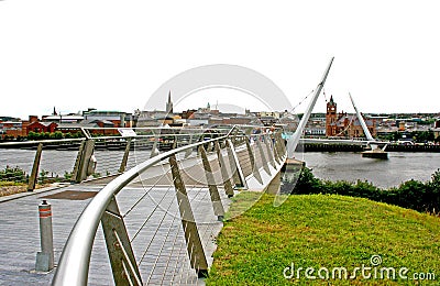Pedestrians crossing the Derry Peace Bridge towards the walled city Editorial Stock Photo